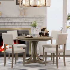 a dining table with four chairs and a fire place in the fireplace area behind it