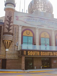 the front of a building with an american flag on top