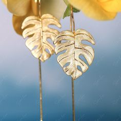 Add these stunning monstera leaf dangle drop earrings to your jewelry collection or give them as a gift to a loved one. The elegant design features a monstera leaf shape with long ear wire drop, made of 925 sterling silver. You can choose between a gold plated option with a brushed texture for a realistic feel, or a highly polished pure silver option for a brilliant shine. These earrings are a must-have for any fine jewelry enthusiast. Sold as a pairMaterials: 925 sterling silverFinish: gold pla Minimalist Leaf-shaped Ear Wire Jewelry, Monstera Leaf, Silver Drop Earrings, Ear Wire, Leaf Shapes, Pure Silver, Elegant Design, Jewelry Collection, Dangle Drop Earrings