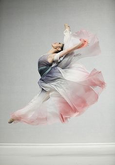 a woman in a dress is flying through the air