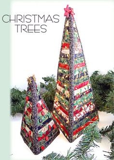 two christmas trees made out of fabric on top of evergreen branches with the words christmas trees written above them