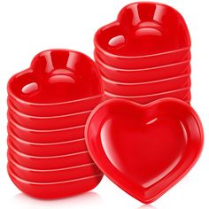 a stack of red heart shaped dishes on a white background