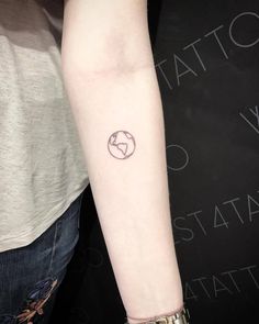 a woman's arm with a small tattoo on the left side of her arm