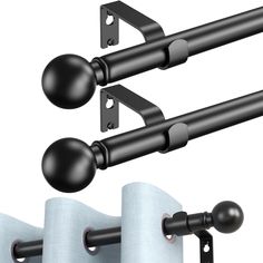 two black curtain rods and one white curtain rod