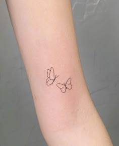 two butterflies tattoo on the arm