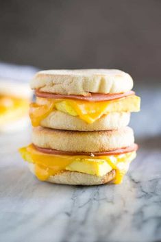 three breakfast sandwiches stacked on top of each other