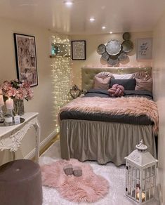 a bedroom decorated in pink and grey with lights on the wall, fur rugs and bedding