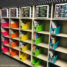 the shelves are filled with colorful bins for children's books to read and write