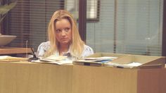 a woman sitting at a desk in an office