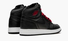 The Air Jordan 1 GS “Black Satin” is the youth sizing of lifestyle-focused high-top featuring a premium finish applied to its upper.  Now firmly entrenched as one of streetwear’s most essential styles, the high-top Jordan 1 is more at home on the streets than the courts these days, and the materials used on this colorway speak to that sentiment.  A black satin material is applied to the toe, mid-panel and collar.  Black leather overlays appear on the forefoot, toe cap, collar and heel.  Tonal si High Top Jordans, Air Jordan 1 High, Kids Jordans, Jordan 1 High, Satin Material, Red Shoes, Wedge Sneaker, Air Jordan 1, Black Satin