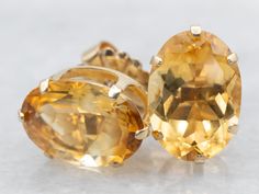 These citrines are fiery and fierce, these amber-hued gemstones are citrine, some of the finest that we've seen. The color is warm, orange-russet with plenty of sparkles! Metal: 14K Yellow GoldGem: 2 Citrine totaling 9.38 Carats