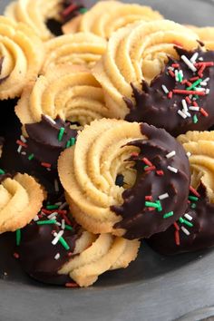 chocolate covered cookies with sprinkles on a plate