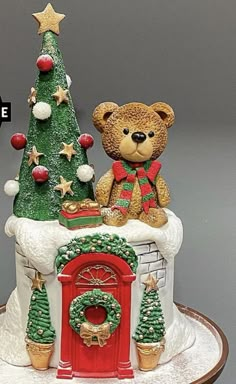 a teddy bear sitting on top of a christmas cake