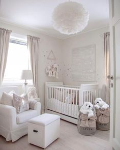 a baby's room with white furniture and decor