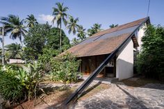 an upside down house in the middle of palm trees