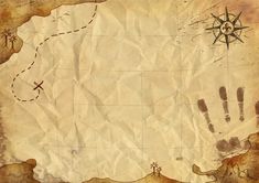 an old map with two hand prints on it and a compass pointing to the left