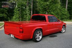 a red pick up truck parked in a parking lot