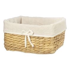 a white and beige basket with a bow on it