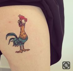 a woman's thigh with a rooster tattoo on it