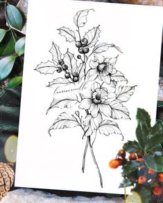 a card with flowers on it next to some pine cones and holly leaves, surrounded by other christmas decorations