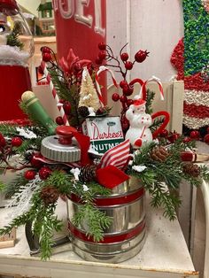 a bucket filled with christmas decorations on top of a table