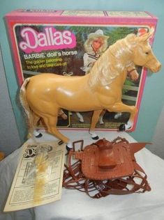 a toy horse and other toys on a table with a magazine in front of it