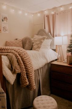 a bed room with a neatly made bed and a christmas tree