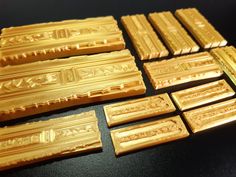 several pieces of gold that are sitting on a table