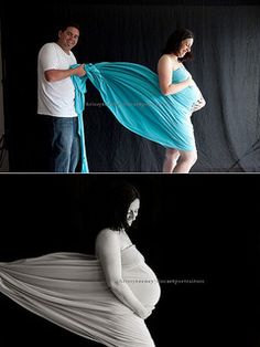 a pregnant woman is wrapped in blue fabric while her husband stands next to her and looks at the camera