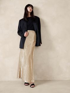 We knew we needed a minimalist silhouette to truly showcase this special sequin fabric, comprised of shining paillettes in either black or a mix of silver and gold.  Here, a fluted maxi skirt cut on the bias let the fabric take center stage.  A-line fit.  Invisible zip at wearer's left.  Fully lined.  A-line fit.  Maxi length.  Model: Size S, 5'10" (178cm). Sequin Maxi Skirt, Sequence Skirt, Maxi Sequin Skirt, Ny Outfits, Tan Skirt, Maxi Skirt Outfits, Houndstooth Skirt, Minimalist Silhouette, Sequin Maxi