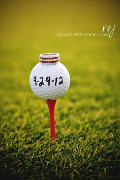 a golf ball sitting on top of a red tee