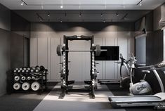 there is a gym with many machines and exercise equipment in the room, including treadmills