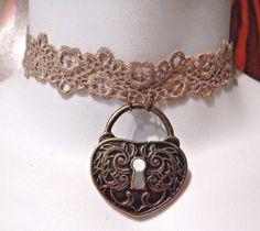 "taupe brown choker made of narrow Venetian lace ribbon.  bronze padlock shaped pendant, and adjustable bronze chain clasp in back.  adjusts between about 12 to 14.5\" around, so will fit necks between 11.5 to 14\" around" Adjustable Bronze Choker As A Gift, Bronze Adjustable Choker, Arryn House, House Necklace, Metal Choker Necklace, Key Charm Necklace, Friends Necklace, 5 Friends, 50th Anniversary Gifts