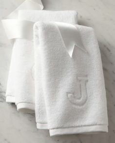 two white towels with the letter j on them