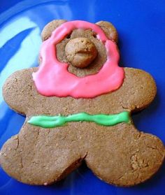 a cookie shaped like a teddy bear with frosting on it