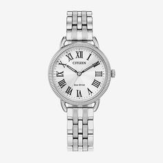 A modern twist on a classic design. Featuring an elegant silver-tone case with a textured, coin edge bezel and silver-tone 3-hand dial with bold roman numerals, this sleek watch stands out from the crowd while remaining understated. A silver-tone stainless steel fold-over clasp fastens this watch for a minimalist look. Sustainably powered by light with eco-drive technology, this watch never needs a battery and offers a refined look and upscale feel.Features: Quick ShipBattery Type: Lithium IonJe Sleek Watch, Eco Drive Watches, Citizen Watch, Citizen Eco, Eco Drive, Classic Watches, White Dial, Stainless Steel Watch, Minerals Crystals