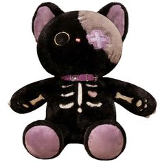 a black and white stuffed animal with a cross on it's chest