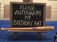 a sign that says please autograph my birthday bat on top of a baseball bat