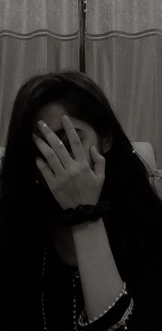 a woman covering her face with her hands