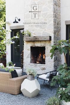 an outdoor fireplace in the middle of a patio