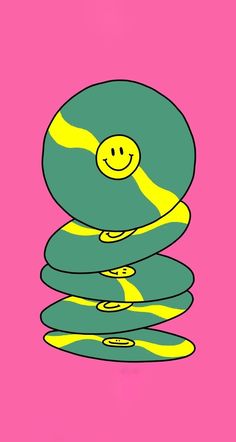 a smiley face sitting on top of a stack of rocks in pink and green colors