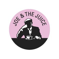 the joe and the juice logo on a pink circle with a man sitting at a table