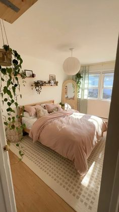 a bed sitting in a bedroom next to a window with plants growing on the wall