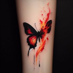 a red and black butterfly tattoo on the right leg with watercolor paint splatters