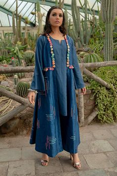 Blue long jacket, enhanced with multi-colored flower hand embroidery. Paired with bell sleeve kurta and flared hem pant.
Component: 3
Pattern: Hand Embroidery
Type Of Work: Danka,Thread Embroidery,Floral
Neckline: Notched Neck
Sleeve Type: Full Sleeves
Fabric: Dupion Art Silk and Cotton Satin
Color: Blue
Other Details: 
Side pleated kurta
Occasion: Sangeet - Aza Fashions Tassel Jacket, Kurta Set For Women, Satin Hands, Dress Design Patterns, Sleeves Ideas, Hand Embroidery Flowers, Designer Dresses Casual, Embroidery Floral, Work Jacket