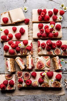 several slices of cake with raspberries and other toppings on top of it