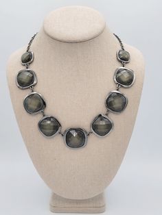 Vintage NY Brand Black Gunmetal & Shimmering Green Faceted Stone Bib Necklace  This pretty necklace makes a great statement piece.   A black gunmetal cable chain necklace secures with a lobster claw clasp & is adjustable for length.  The chain is affixed at both ends to a linked bib of rounded square-shaped settings that hold large faceted dark green shimmering stones.  This piece is in excellent, nearly new condition.    Dimensions: 23 inches in length maximum Clasp: Lobster Claw Markings: NY Condition: Excellent - nearly new All of my shop items are pre-owned vintage.  All pieces should be expected to have some vintage wear unless otherwise stated.   Great for the vintage & costume jewelry lover!  Be sure to check out our other vintage jewelry listings! Looking for something that isn't l Adjustable Gunmetal Necklaces For Party, Adjustable Gunmetal Necklace For Party, Adjustable Nickel-free Gunmetal Necklace, Adjustable Gunmetal Nickel-free Necklace, Gray Metal Chain Necklace, Party Gunmetal Metal Necklaces, Party Necklaces In Gunmetal Metal, Formal Gunmetal Metal Jewelry, Gunmetal Party Necklace