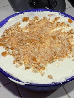 a blue and white bowl filled with food on top of a counter