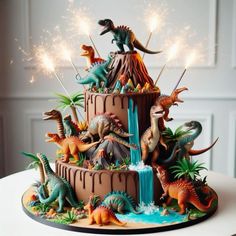 a birthday cake decorated with dinosaur figurines and sparklers in the shape of a waterfall