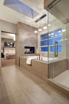 a bathroom with a large tub and a fireplace in the corner, along with a walk - in shower